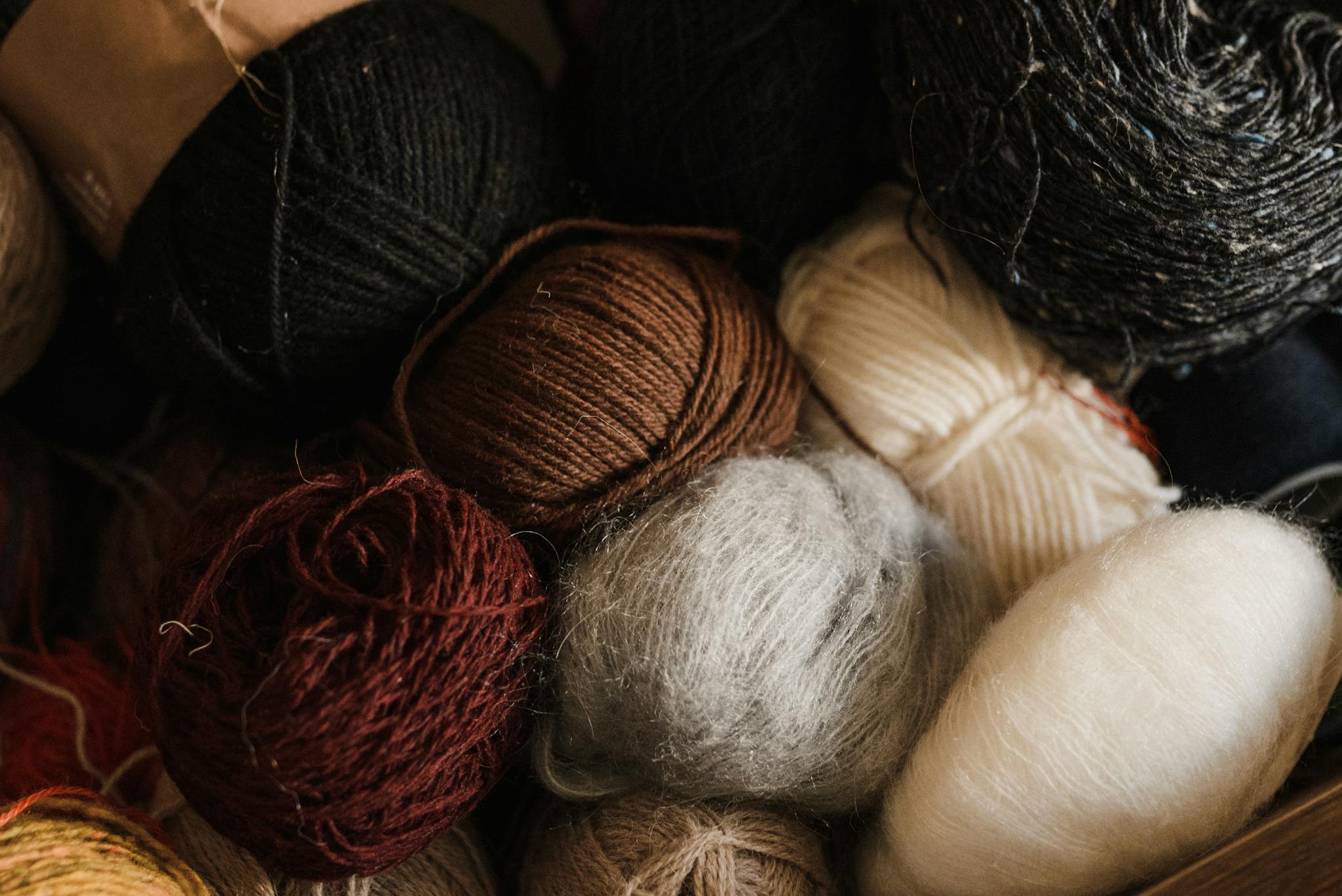 A close-up view of assorted colorful yarn balls, perfect for knitting and crafts.